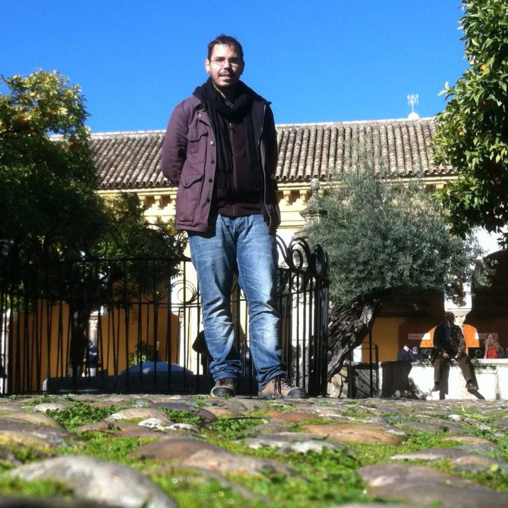 a professor standing in a courtyard