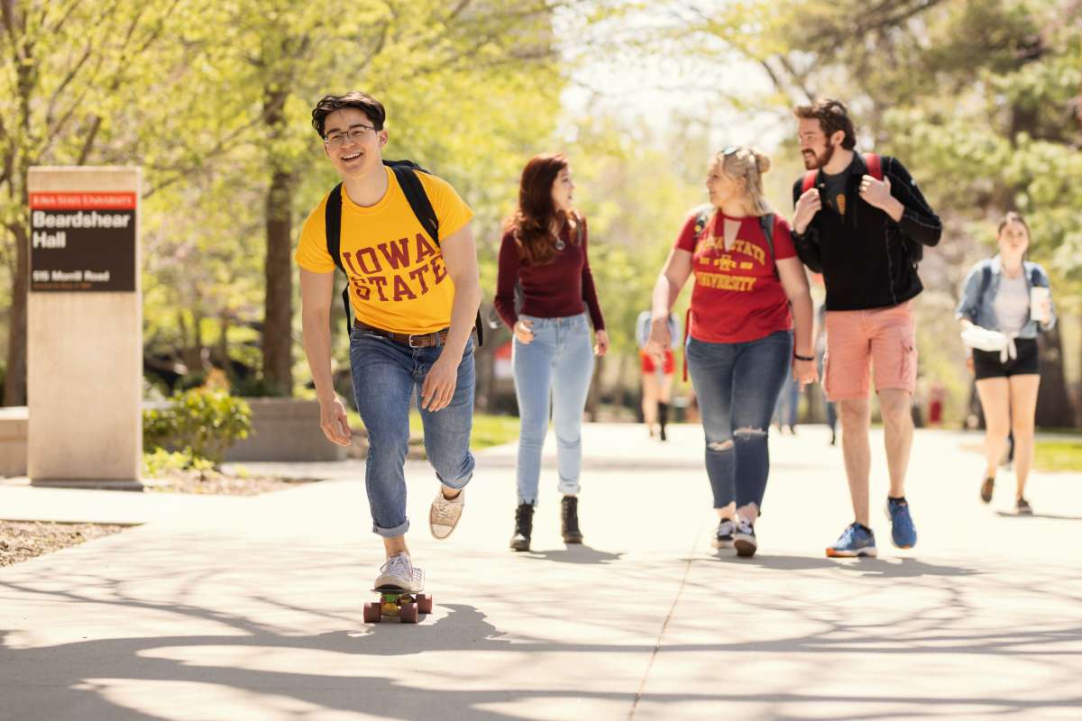 Several students walking outside Beardshear Hall at Iowa State